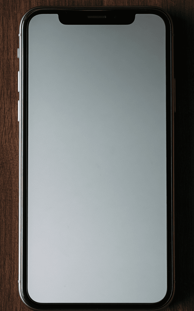 A phone face up on a kitchen counter, its screen full of unanswered messages.